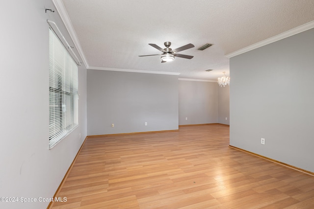 empty room with crown molding, light hardwood / wood-style flooring, and ceiling fan with notable chandelier