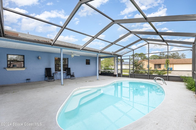 view of pool with a patio area, ceiling fan, and a lanai