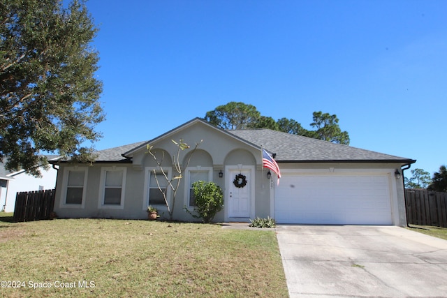 ranch-style home with a front lawn and a garage