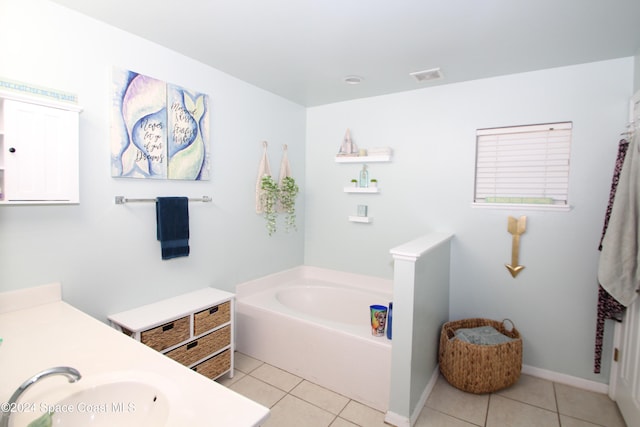 bathroom featuring a tub to relax in, tile patterned flooring, and vanity