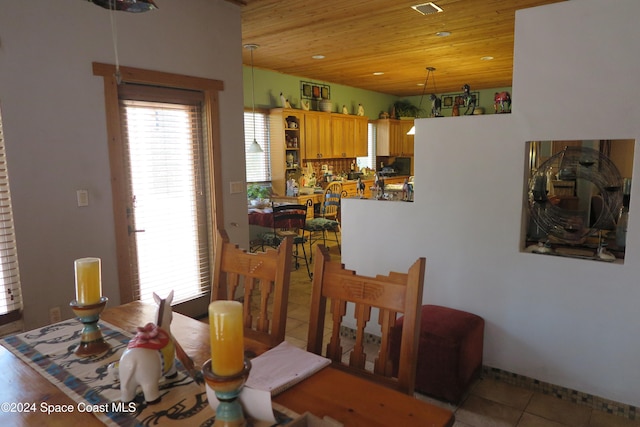 dining room with light tile patterned floors and wooden ceiling