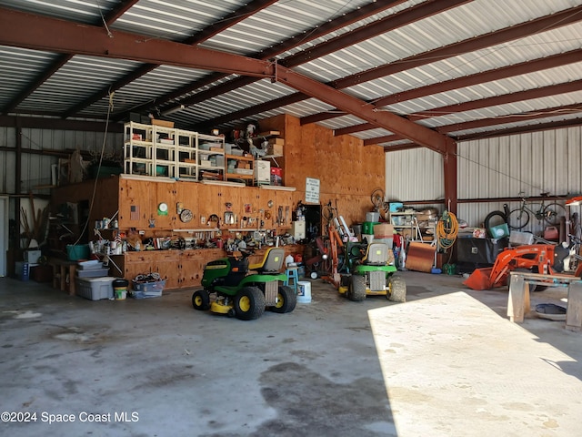 garage with a workshop area and wooden walls