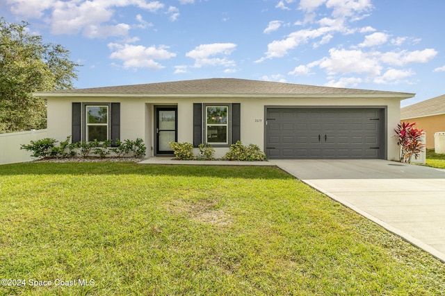 single story home with a front yard and a garage