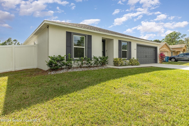 ranch-style home with a garage and a front yard