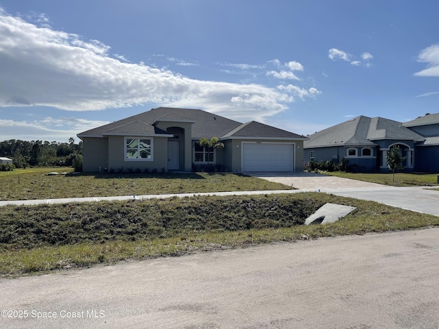 view of front of house with a front lawn and a garage