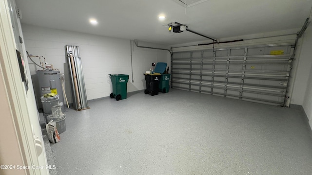 garage with electric water heater and a garage door opener