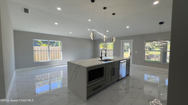 kitchen with appliances with stainless steel finishes, light stone countertops, hanging light fixtures, and a wealth of natural light