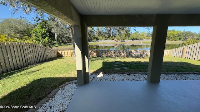 view of yard with a patio area and a water view