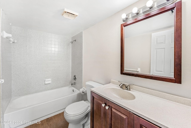 full bathroom with toilet, vanity, tiled shower / bath combo, and hardwood / wood-style flooring