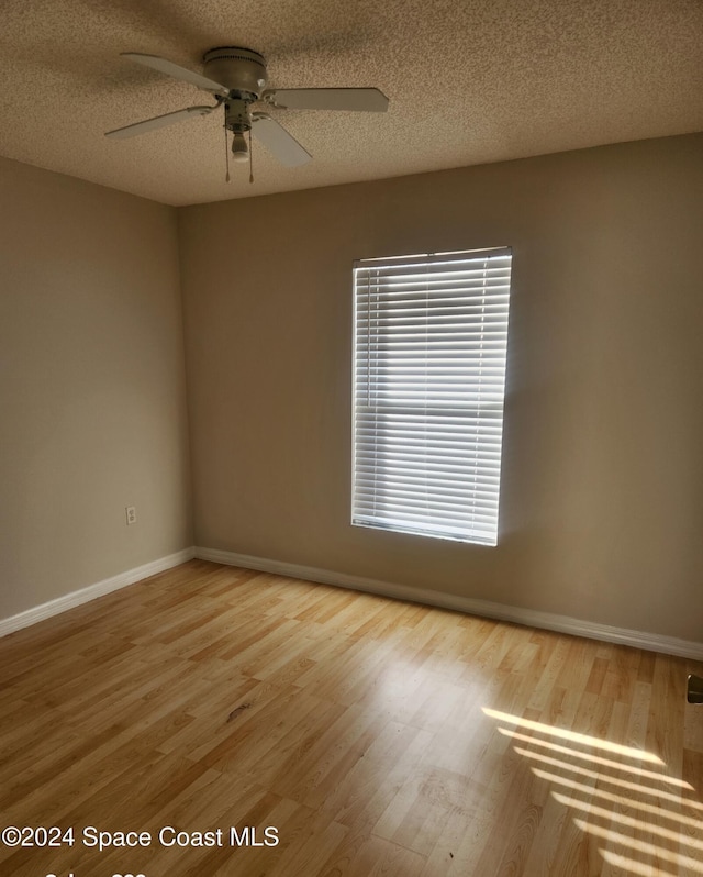 unfurnished room featuring ceiling fan, a textured ceiling, and hardwood / wood-style flooring