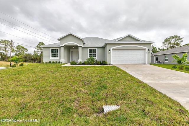 view of front of house with a front yard and a garage