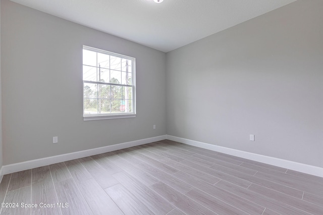 unfurnished room with light hardwood / wood-style flooring