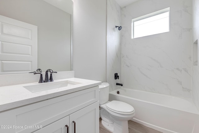 full bathroom featuring toilet, vanity, tiled shower / bath combo, and hardwood / wood-style flooring