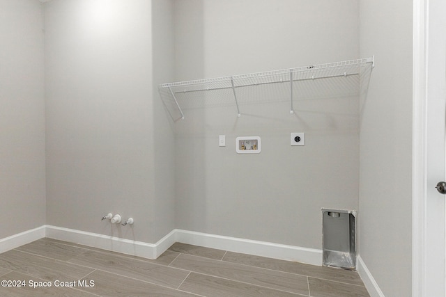 laundry room featuring washer hookup, hookup for a gas dryer, electric dryer hookup, and wood-type flooring