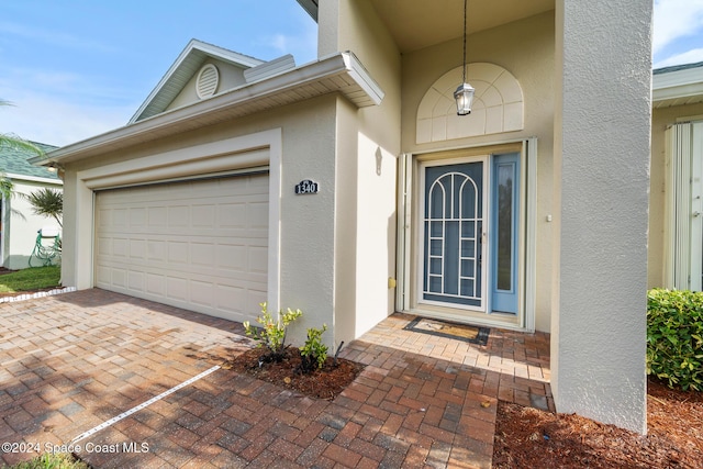 view of exterior entry featuring a garage