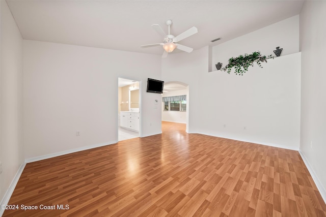 unfurnished living room featuring ceiling fan, high vaulted ceiling, and light hardwood / wood-style floors