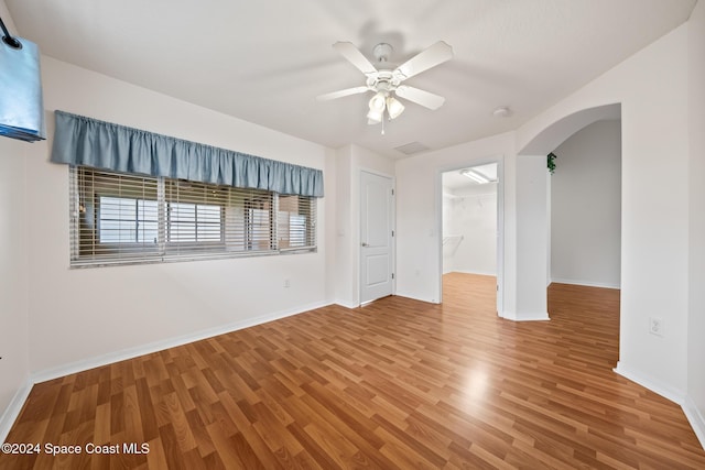 empty room with hardwood / wood-style flooring and ceiling fan