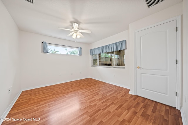 unfurnished room with hardwood / wood-style flooring and ceiling fan