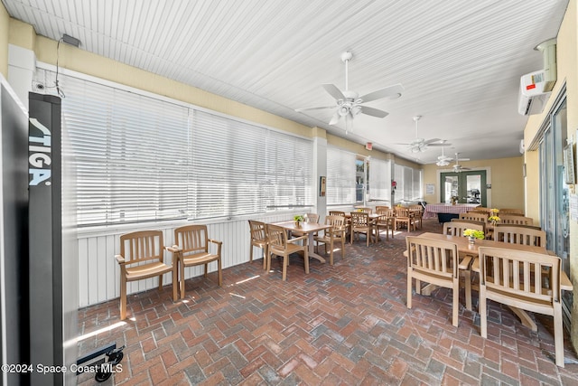 sunroom / solarium featuring a wall mounted AC and plenty of natural light