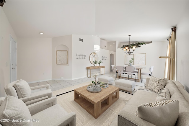 living room with light tile patterned flooring and a chandelier