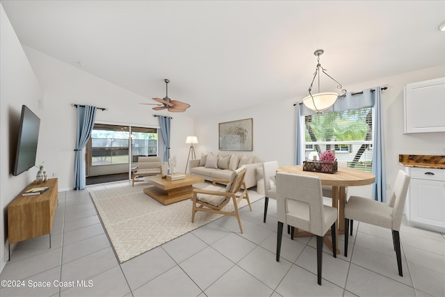 tiled living room featuring ceiling fan and vaulted ceiling