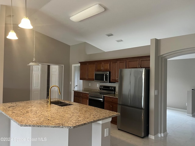 kitchen featuring decorative light fixtures, sink, stainless steel appliances, and lofted ceiling