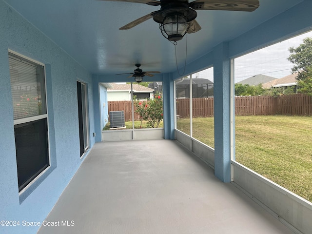 unfurnished sunroom featuring ceiling fan