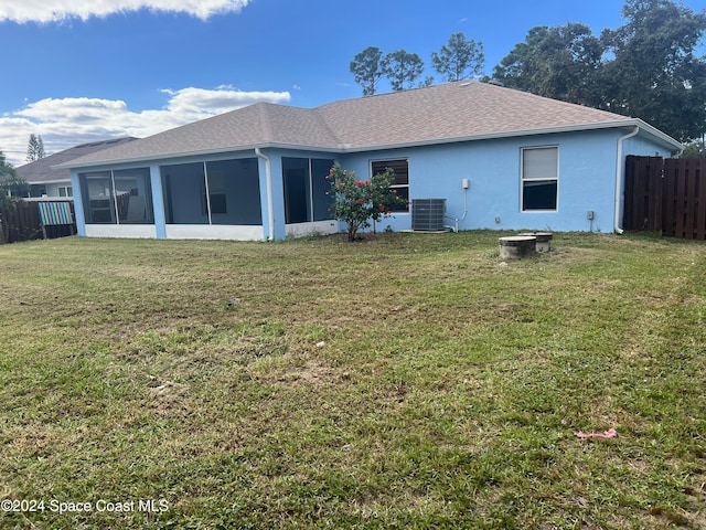 back of property featuring a lawn, a sunroom, and cooling unit