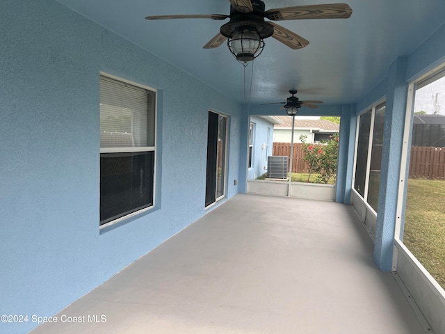 unfurnished sunroom with ceiling fan