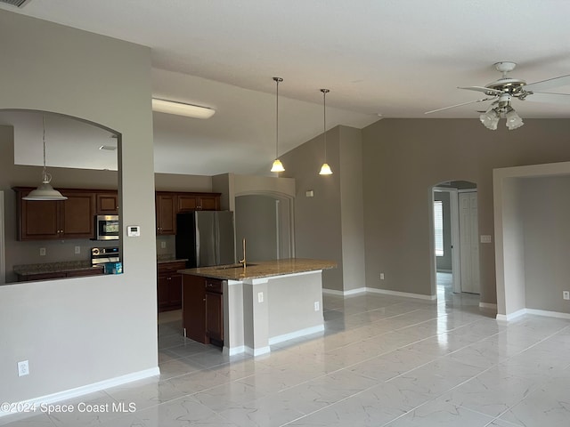 kitchen featuring ceiling fan, an island with sink, appliances with stainless steel finishes, and vaulted ceiling