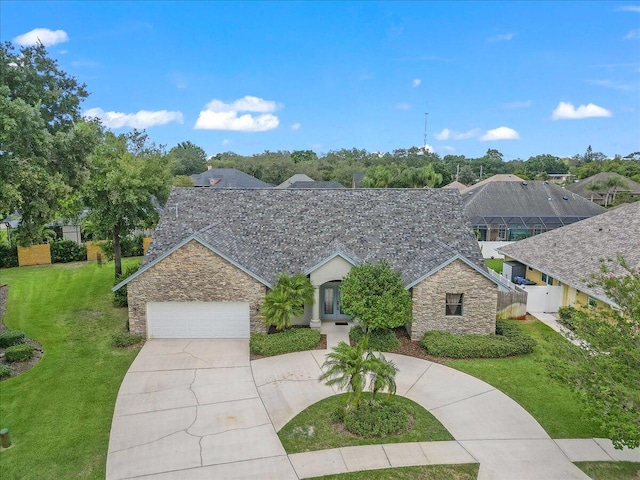 view of front of home with a garage and a front lawn