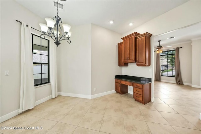 kitchen with light tile patterned floors, ceiling fan with notable chandelier, and pendant lighting