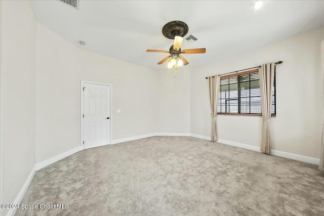 carpeted spare room with ceiling fan