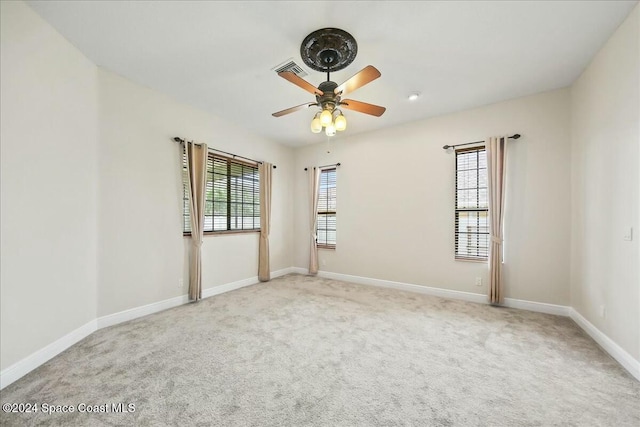 empty room with ceiling fan and light colored carpet