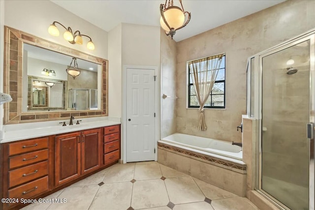 bathroom with tile patterned floors, vanity, and separate shower and tub