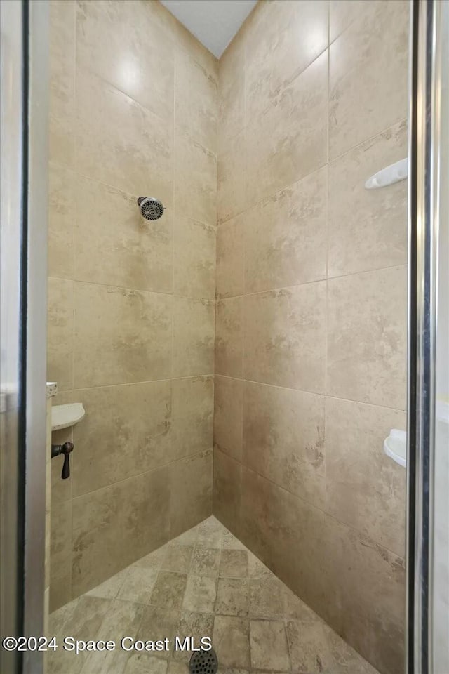 bathroom with tiled shower