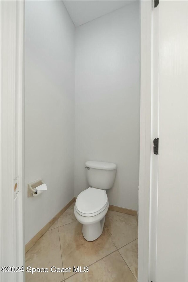 bathroom featuring tile patterned flooring and toilet