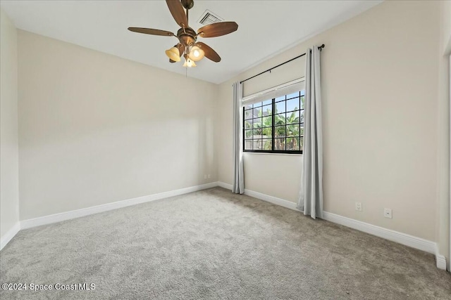 empty room featuring ceiling fan and light colored carpet