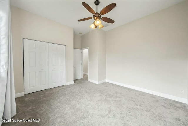 unfurnished bedroom featuring carpet flooring, ceiling fan, and a closet