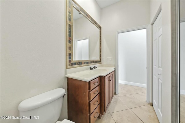 bathroom featuring toilet, vanity, and tile patterned floors