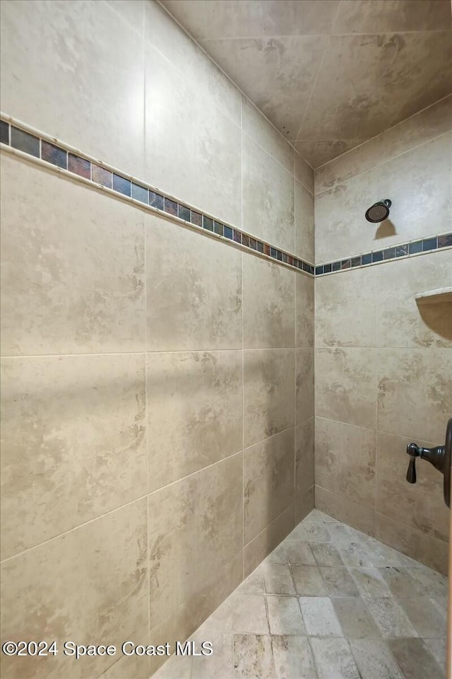 bathroom with tiled shower