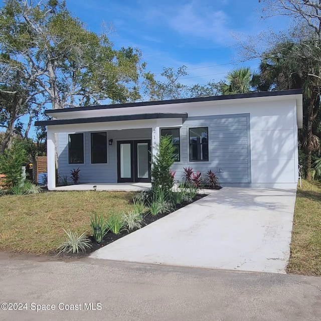 205 Flamingo Dr, Cocoa, FL 32926 - view of front of property with concrete driveway, french doors, and covered porch