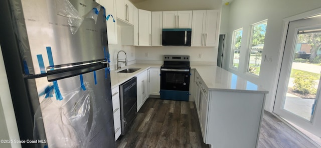 205 Flamingo Dr, Cocoa, FL 32926 - kitchen with stainless steel appliances, dark wood-type flooring, a peninsula, and white cabinets