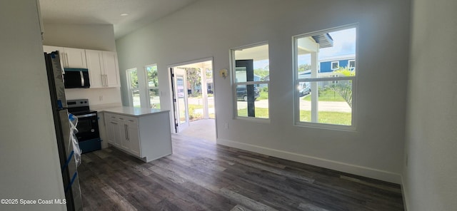 205 Flamingo Dr, Cocoa, FL 32926 - kitchen featuring stainless steel appliances, a peninsula, white cabinetry, dark wood-style floors, and light countertops