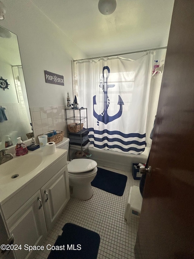 full bathroom featuring vanity, shower / bath combination with curtain, tile walls, and toilet