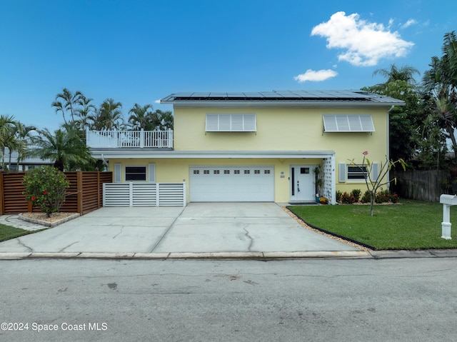 491 Indian Creek Dr, Cocoa Beach, FL 32931 - view of front facade featuring solar panels, stucco siding, a balcony, and concrete driveway
