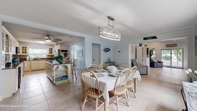 491 Indian Creek Dr, Cocoa Beach, FL 32931 - dining area with light tile patterned flooring, crown molding, and a ceiling fan