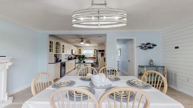 491 Indian Creek Dr, Cocoa Beach, FL 32931 - dining area with wine cooler, ornamental molding, a ceiling fan, and wood walls