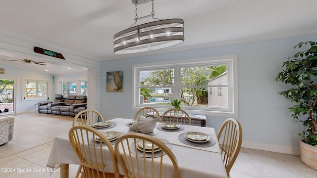 491 Indian Creek Dr, Cocoa Beach, FL 32931 - dining room featuring healthy amount of natural light, light tile patterned floors, ceiling fan, and vaulted ceiling
