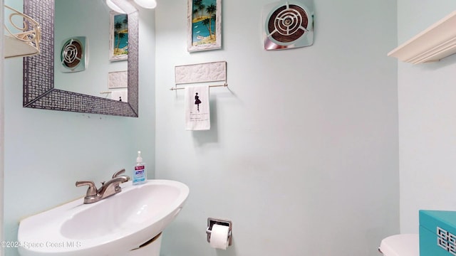 491 Indian Creek Dr, Cocoa Beach, FL 32931 - half bathroom with a sink and toilet